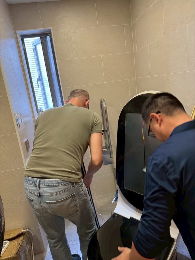 The crew fine-tuning the unit on site